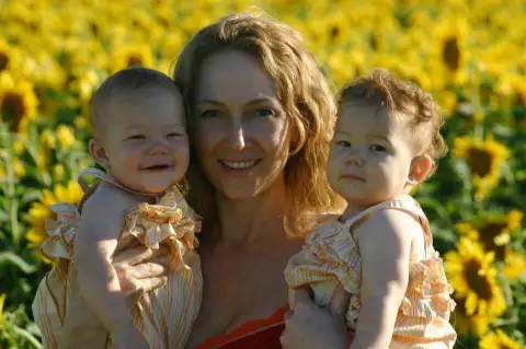 Jean Muggli holding her Twin Daughters.